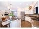 Kitchen with an island, breakfast bar seating, stainless appliances, and a view to the living area at 5479 Baytowne Pl, Oviedo, FL 32765