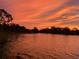 Gorgeous lake view with dramatic sunset, creating a serene and picturesque setting at 5479 Baytowne Pl, Oviedo, FL 32765