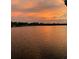 Beautiful and expansive lake view with calm waters and picturesque sunset at 5479 Baytowne Pl, Oviedo, FL 32765