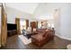 Living room featuring high ceilings, a leather sectional, hardwood floors, and neutral paint colors at 5479 Baytowne Pl, Oviedo, FL 32765