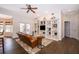 Comfortable living room boasts hardwood floors, built-in shelving, and abundant natural light from the French doors at 5479 Baytowne Pl, Oviedo, FL 32765