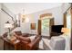 Inviting living room featuring hardwood floors, a leather couch, and staircase to the second level at 5479 Baytowne Pl, Oviedo, FL 32765