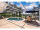 Inviting pool area with outdoor seating, lush landscaping, and clear pool water at 5479 Baytowne Pl, Oviedo, FL 32765