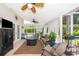 Relaxing sunroom furnished with a comfortable sofa and chairs and a ceiling fan at 5479 Baytowne Pl, Oviedo, FL 32765