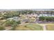 Aerial shot showcases a community center with a pool, tennis courts, and a putting green at 6125 Foxfield Ct, Windermere, FL 34786