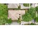 Aerial view of a tile-roofed home featuring manicured landscaping and a brick driveway at 6125 Foxfield Ct, Windermere, FL 34786