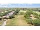 Aerial view of homes lining a golf course with mature trees and green fairways at 6125 Foxfield Ct, Windermere, FL 34786