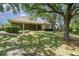 Beautiful backyard with mature trees, lush landscaping, and a covered patio, perfect for outdoor entertaining at 6125 Foxfield Ct, Windermere, FL 34786