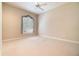 Bedroom with neutral walls and carpet, large window, and ceiling fan at 6125 Foxfield Ct, Windermere, FL 34786