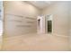 Spacious bedroom with neutral carpet, shelving, and access to the walk-in closet at 6125 Foxfield Ct, Windermere, FL 34786