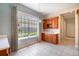 Charming breakfast nook area with custom built-ins and natural light from large windows at 6125 Foxfield Ct, Windermere, FL 34786