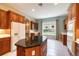 Bright kitchen with a granite top island, custom wood cabinetry, and modern appliances at 6125 Foxfield Ct, Windermere, FL 34786