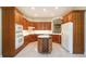 Spacious kitchen boasting custom wood cabinets and a central island with wine storage at 6125 Foxfield Ct, Windermere, FL 34786