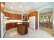 Well-appointed kitchen featuring wood cabinetry, island, and seamless access to the dining area at 6125 Foxfield Ct, Windermere, FL 34786