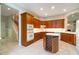 Gourmet kitchen with custom wood cabinetry, a wine rack island, and modern appliances at 6125 Foxfield Ct, Windermere, FL 34786