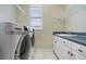 Functional laundry room equipped with modern appliances and ample counter space at 6125 Foxfield Ct, Windermere, FL 34786
