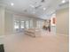 Expansive living area with plush carpeting, neutral walls, and French doors providing ample natural light at 6125 Foxfield Ct, Windermere, FL 34786