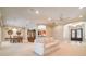 Open-concept living room with a comfortable sofa, dining area, and a view into the kitchen and front entryway at 6125 Foxfield Ct, Windermere, FL 34786