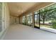Expansive screened-in patio overlooking the golf course provides a relaxing outdoor living space with ceiling fans at 6125 Foxfield Ct, Windermere, FL 34786