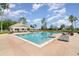 Community pool area featuring sun loungers, shaded areas, and a pristine pool for residents to enjoy at 6125 Foxfield Ct, Windermere, FL 34786