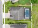 Aerial view of a home with a screened in pool, landscaped backyard and paved driveway at 676 Bishop Bay Loop, Apopka, FL 32712