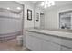 Bright bathroom featuring granite counters, a full mirror, a tub, and a neutral color palette at 676 Bishop Bay Loop, Apopka, FL 32712