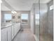 Modern bathroom with double vanity, granite countertops, and a glass-enclosed shower at 676 Bishop Bay Loop, Apopka, FL 32712