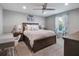 Comfortable bedroom with a ceiling fan, desk, decorative items, and a window that lets in natural light at 676 Bishop Bay Loop, Apopka, FL 32712