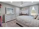 Stylish bedroom featuring white furniture, neutral walls, soft carpeting, and a large window at 676 Bishop Bay Loop, Apopka, FL 32712
