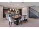 Open-concept dining area with a large dining table and a kitchen island with bar seating at 676 Bishop Bay Loop, Apopka, FL 32712