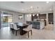 Bright kitchen with a long table, kitchen island and view to the screened-in pool at 676 Bishop Bay Loop, Apopka, FL 32712