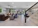 Open-concept living area features a dining table and comfortable seating with a view of the pool at 676 Bishop Bay Loop, Apopka, FL 32712