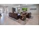 Spacious living room with tile flooring, comfortable seating, and a large screen television at 676 Bishop Bay Loop, Apopka, FL 32712