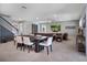 Open-concept living area features a dining table and comfortable seating with a TV for entertaining at 676 Bishop Bay Loop, Apopka, FL 32712