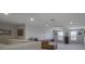 Bright living room with plush carpeting, comfortable seating, natural light, and a view of the staircase at 676 Bishop Bay Loop, Apopka, FL 32712