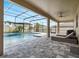Screened-in pool with a mosaic-tiled spa and fountain, surrounded by a stone patio and covered patio with a ceiling fan at 676 Bishop Bay Loop, Apopka, FL 32712