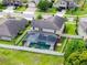Aerial view of a beautiful home with a screened-in swimming pool and a spacious green backyard at 676 Bishop Bay Loop, Apopka, FL 32712