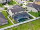 Aerial view of a private backyard featuring a screened-in pool and green landscaping at 676 Bishop Bay Loop, Apopka, FL 32712