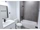 Bathroom featuring modern hardware, neutral paint, a tub and shower combination, and quartz countertops at 699 Marion Oaks Trl, Ocala, FL 34473