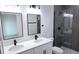 Modern bathroom featuring dual sinks with quartz countertops, matte black hardware and a glass shower at 699 Marion Oaks Trl, Ocala, FL 34473