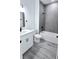 Well lit bathroom featuring gray tile shower, tub, and modern vanity at 699 Marion Oaks Trl, Ocala, FL 34473