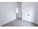 Bedroom featuring gray wood-look flooring, a closet, and a view to the next room at 699 Marion Oaks Trl, Ocala, FL 34473