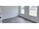Bedroom featuring gray vinyl plank flooring, a large window, and white paint at 699 Marion Oaks Trl, Ocala, FL 34473