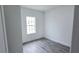Bedroom featuring a window, gray wood-look flooring, and neutral paint at 699 Marion Oaks Trl, Ocala, FL 34473