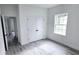 Bright bedroom with light gray vinyl plank flooring and double door closet at 699 Marion Oaks Trl, Ocala, FL 34473