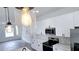 Modern kitchen with stainless steel appliances, white cabinets, and stylish pendant lighting at 699 Marion Oaks Trl, Ocala, FL 34473