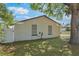 Backyard view featuring brick wall and beautiful trees, enhancing the property's natural appeal at 725 Laurel Way, Casselberry, FL 32707