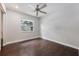 Light and bright bedroom features wood flooring, ceiling fan, closet, and large window at 725 Laurel Way, Casselberry, FL 32707