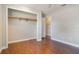 Neutral bedroom with wood-look floors and closet with clothing rod at 725 Laurel Way, Casselberry, FL 32707