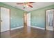 Bedroom with wood-look flooring and ensuite bathroom access at 725 Laurel Way, Casselberry, FL 32707